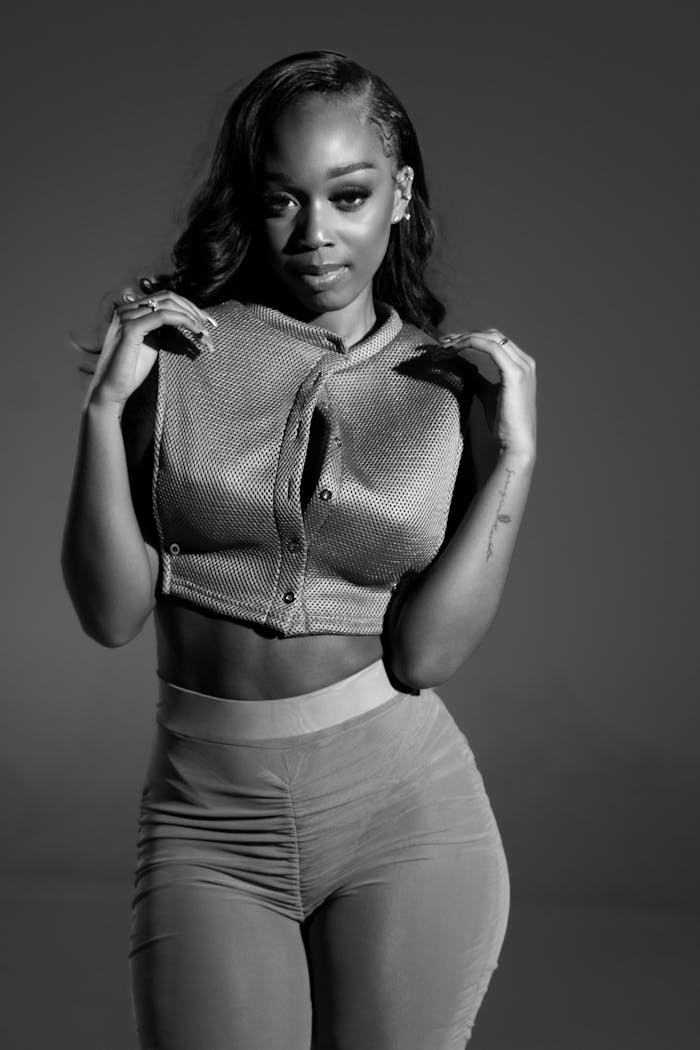 Artistic monochrome portrait of a woman posing gracefully indoors.